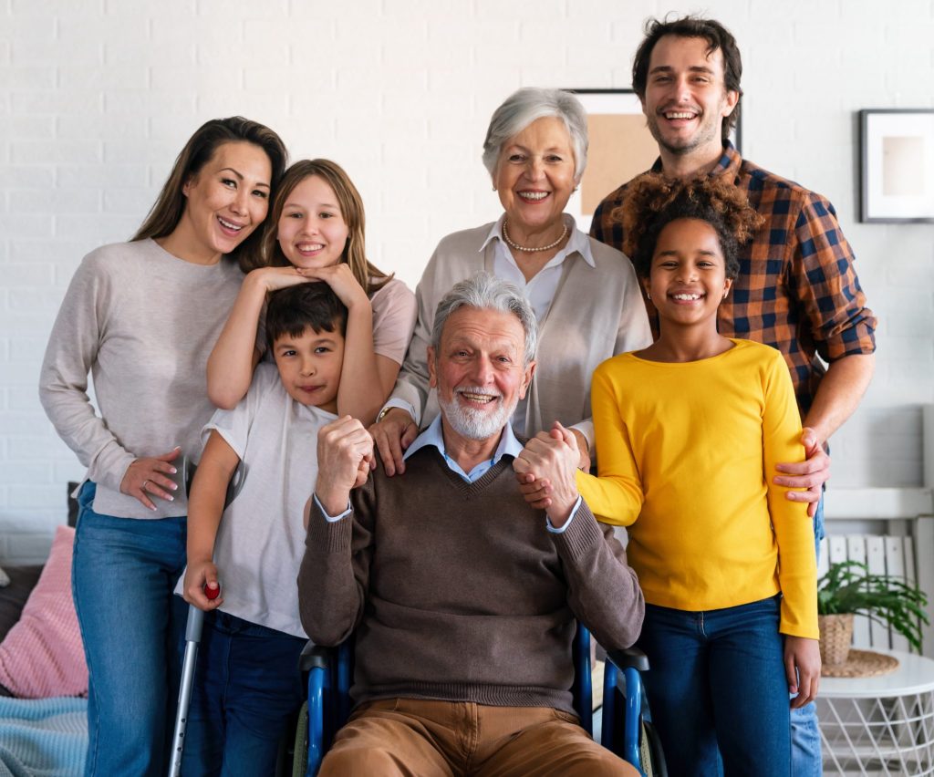 A diverse, multigenerational family featuring adults, seniors, and children, depicted in a warm, supportive setting that represents a family of caregivers.