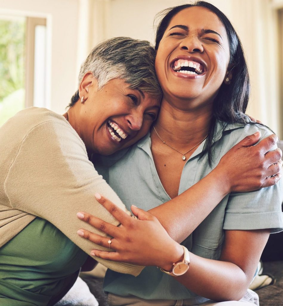 Mom and daughter hugging and laughing
