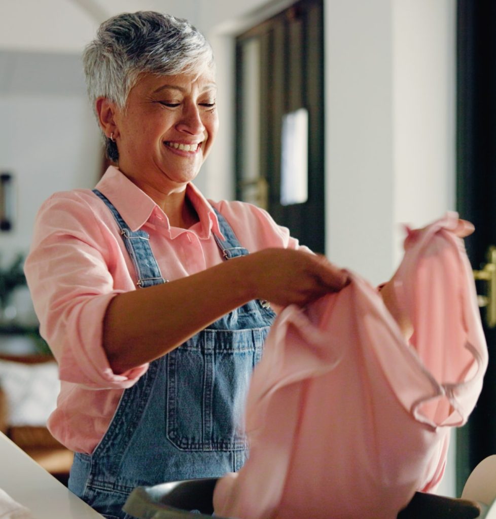 Caregiver folding laundry