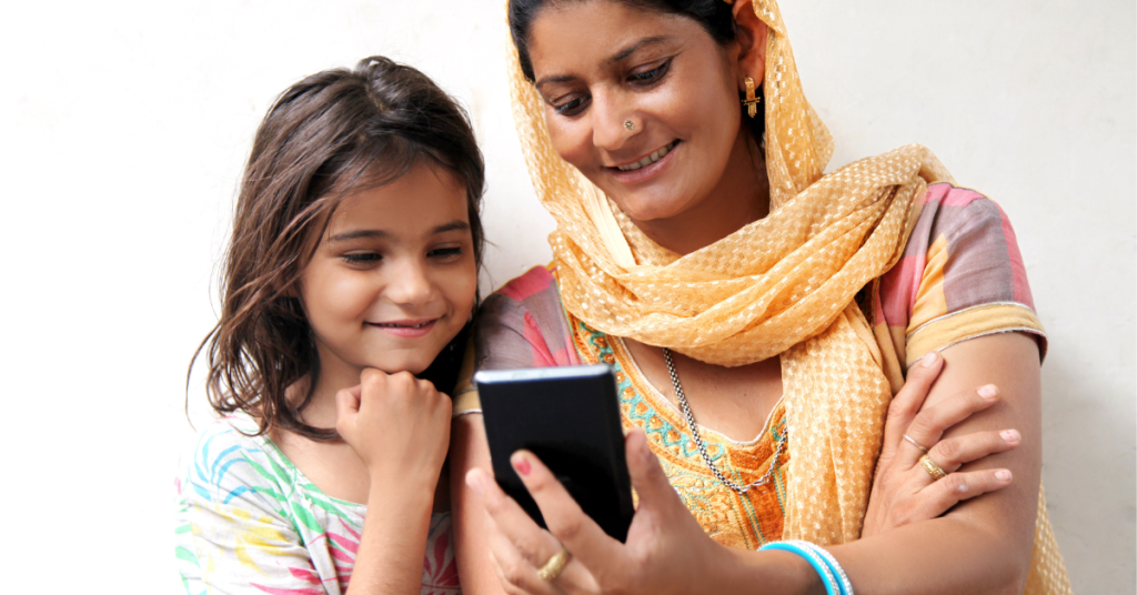 A mother and child use a phone with Assistive Technology apps.
