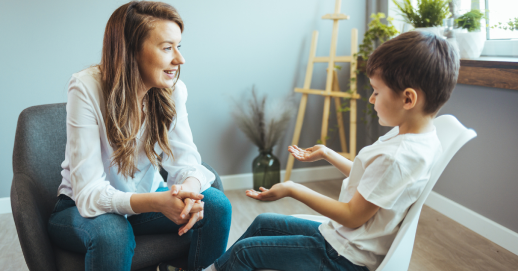 A child with autism speaks with a therapist - autism and mental health disorders.