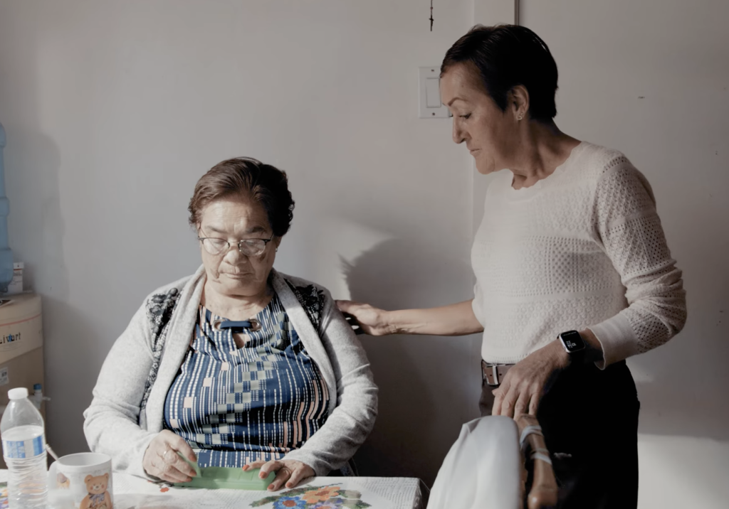 Hispanic woman and her friend at a table